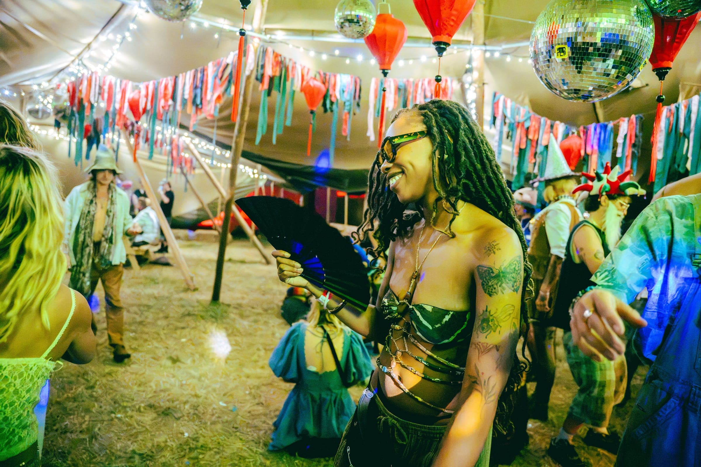 Dancer with a fan under the bunting and lanterns